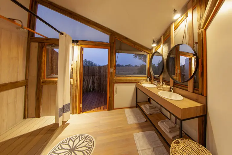 Bathrooms are equipped with flush toilets, double vanities and showers.