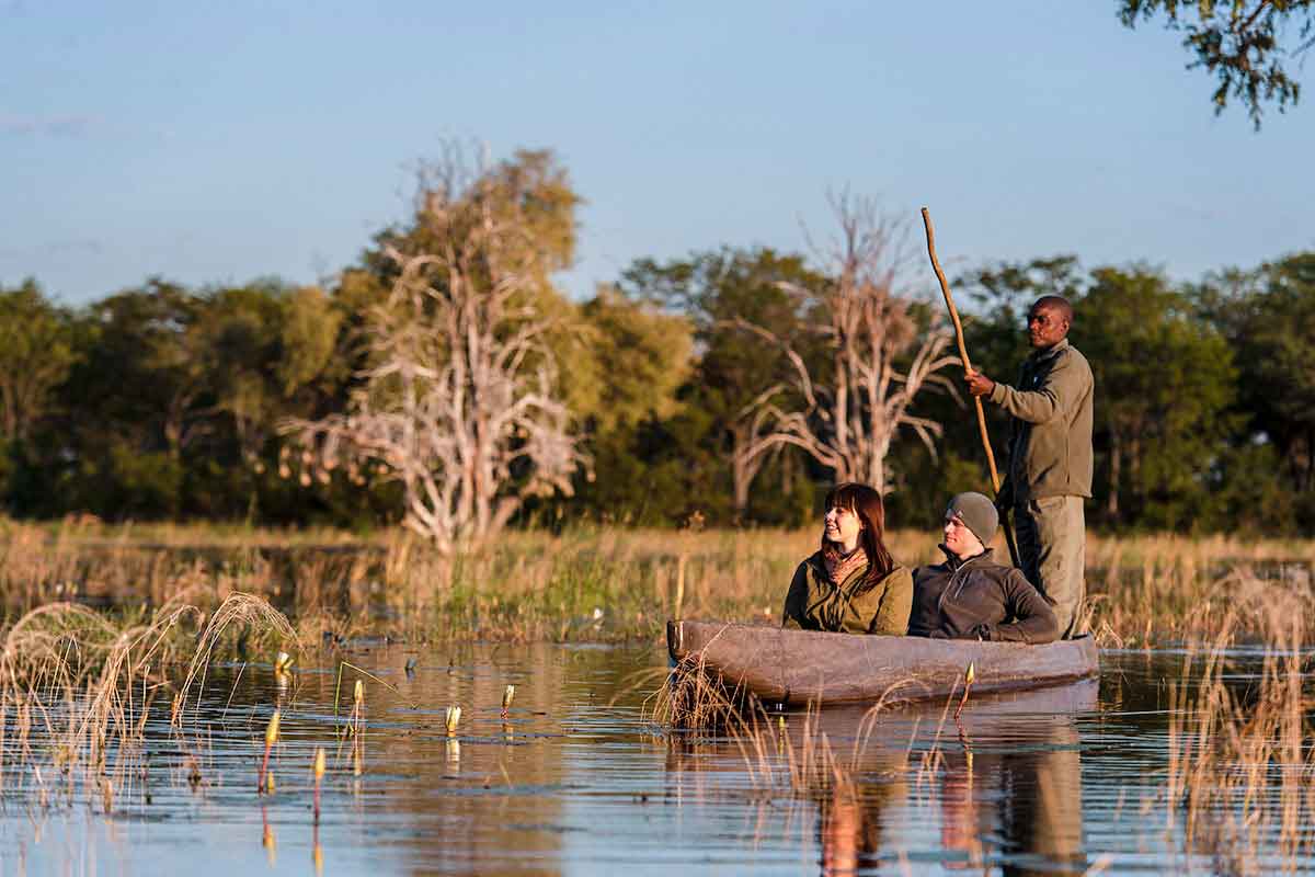 Honeymooners exploring the Okavango Delta on a mokoro, Botswana