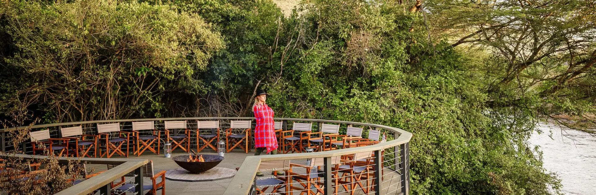 Woman overlooking the river in the Masai Mara, Kenya | Go2Africa