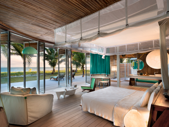 Villas feature floor-to-ceiling windows and sliding doors that offer panoramic views of the Indian Ocean.