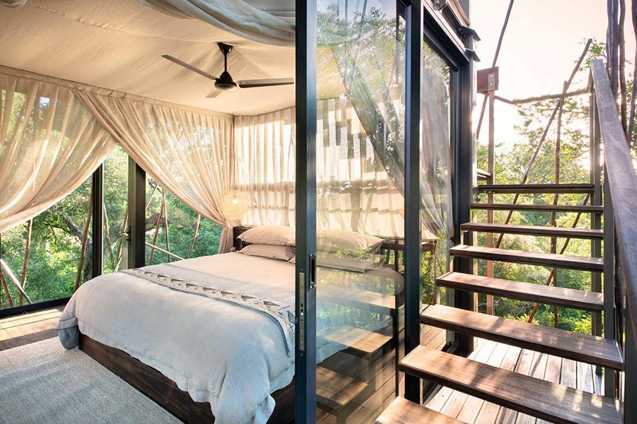 Bed and staircase of the Ngala Treehouse in South Africa.