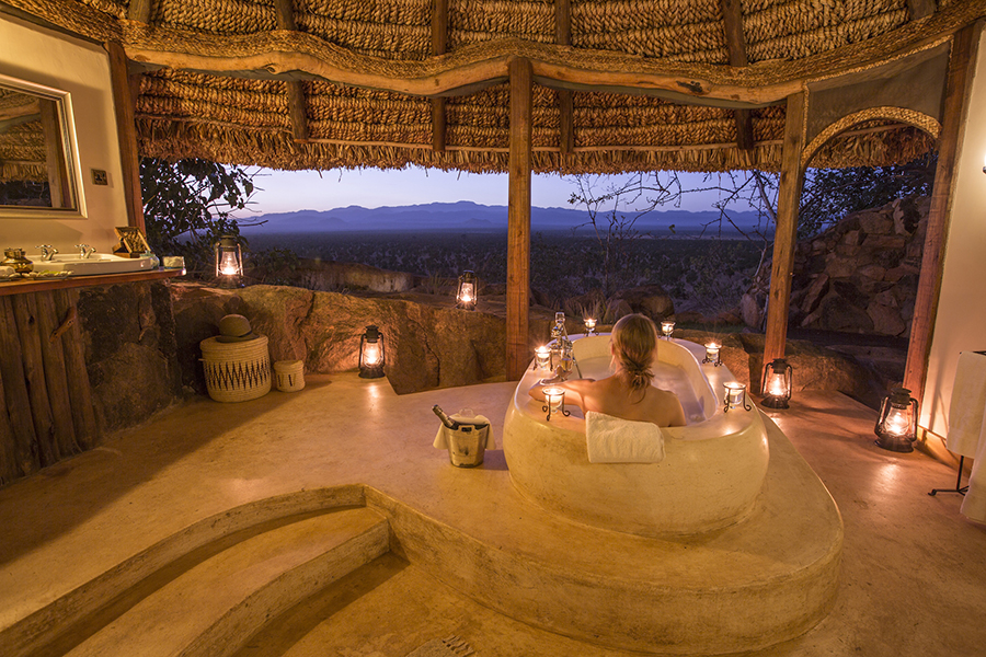 A stone carved bath and thatched roof with open side allows for views over surroundings | Go2Africa