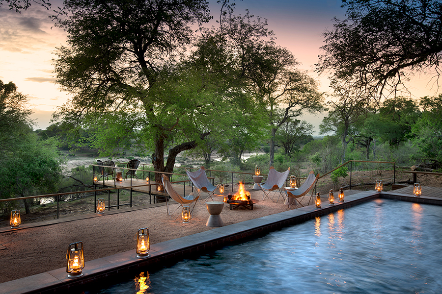 A pool surrounded by lanterns at Lion Sands. 
