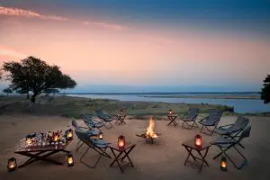 Swap stories with friends and family around a fire as the sun sets.