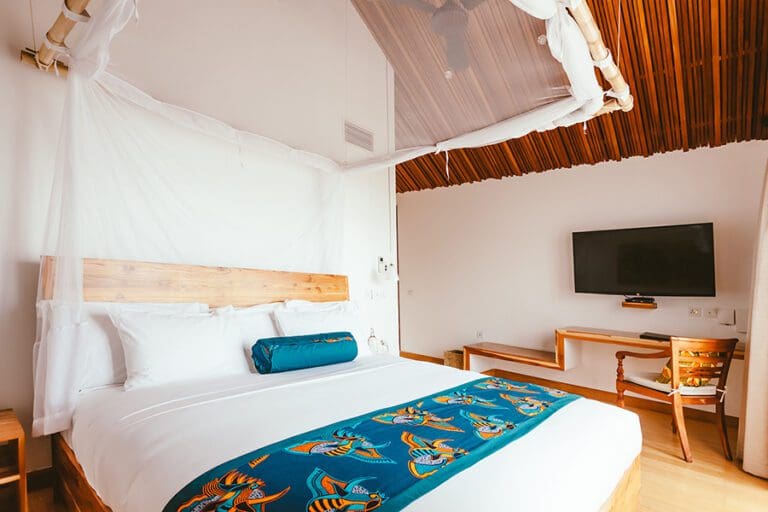 Enjoy a good night's rest in deluxe king suite.
