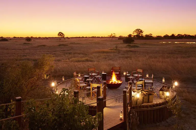 Contempla la puesta de sol junto a la hoguera.