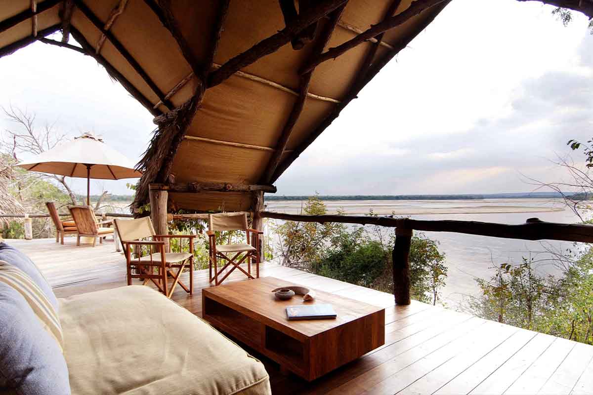 The guest lounge overlooks the tranquil waters of the Rufiji Riverat at Sand Rivers Selous, Tanzania.
