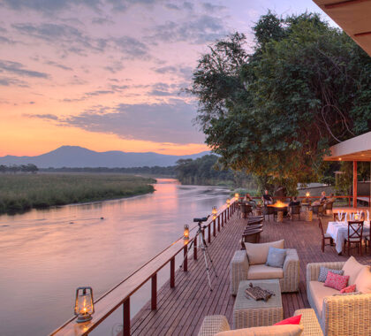 Raised viewing decks at our affordable riverside camps make the perfect spot for a sundowner drink.