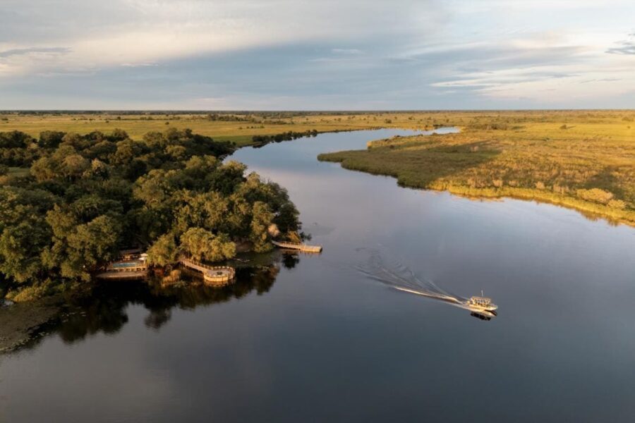 A boat takes off from the shores of Xugana Island Lodge for a water safari on the Okavango Delta