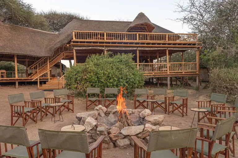 oliver-s-camp-exterior-with-campfire-and-seating