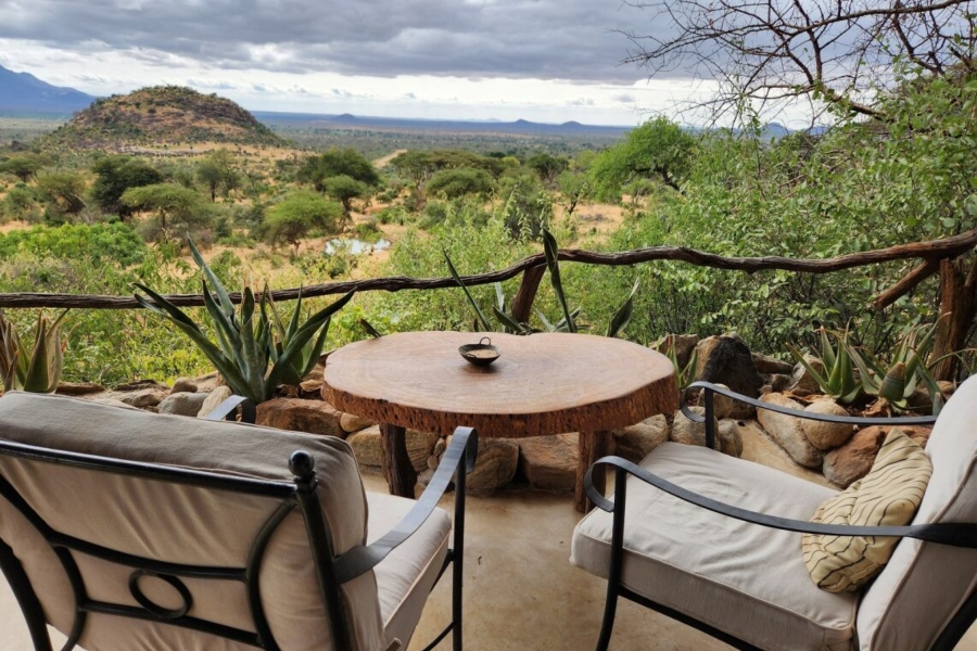 Views from Sarara Camp in Kenya from two chairs and a table across a lush valley | Go2Africa