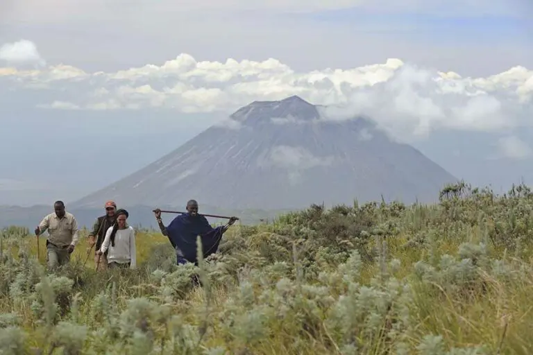 Walking in the shadow of Ol Donyo Lengai volcano.