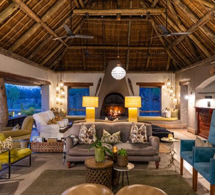 Lounge by the fireplace at Simbambili Lodge.