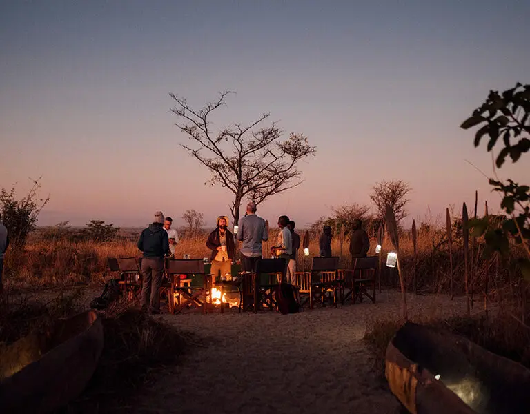 Gathering around the campfire at night.