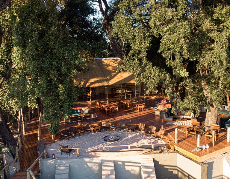 An aerial view shows you Nxamaseri's main lodge area, with a deck and firepit. 