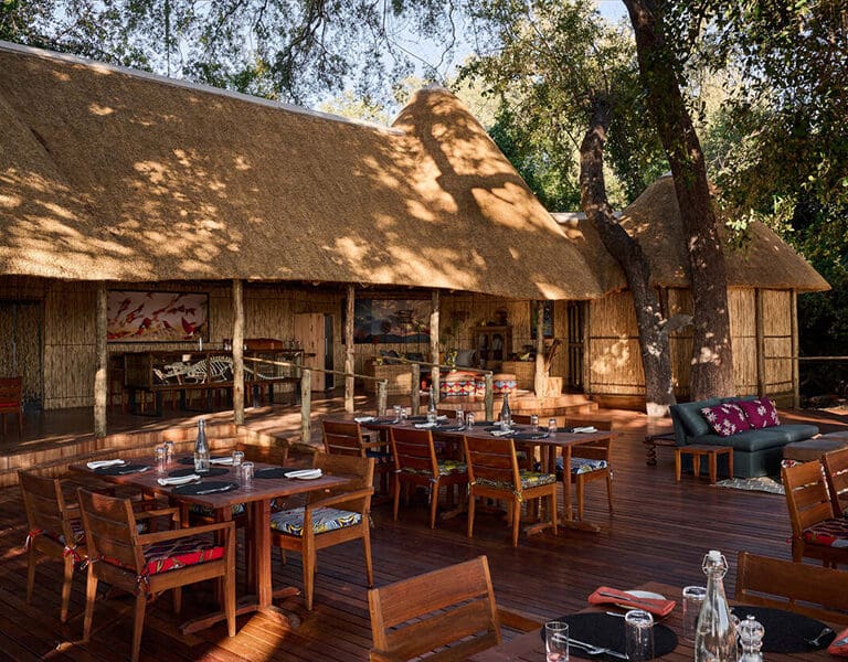 Dine on the deck in the shade of the tall trees surrounding camp. 