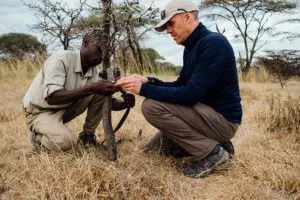 Setting up a camera trap with Usangu Expedition Camp.