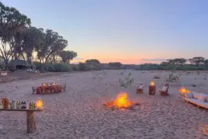Enjoy sundowners on the dry riverbed near the Saruni Rhino Lodge in Kenya.