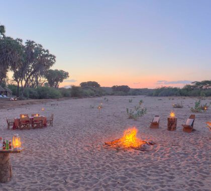 Enjoy sundowners on the dry riverbed near the Saruni Rhino Lodge in Kenya.