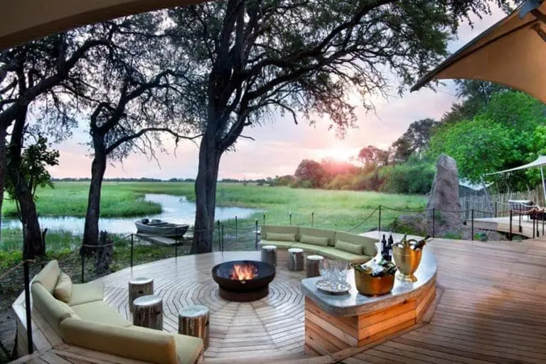 Sit by a crackling fire at Khwai Leadwood in the Moremi Game Reserve.