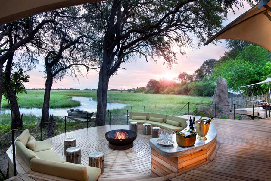 Sit by a crackling fire at Khwai Leadwood in the Moremi Game Reserve