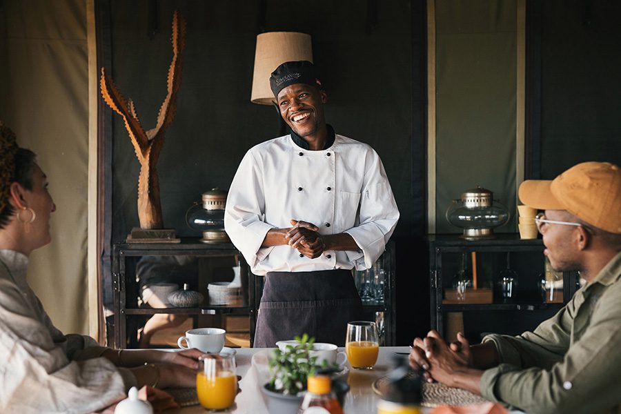 Chef talks to guests about their breakfast at Simbavati Hilltop Lodge in Kruger National Park, South Africa.