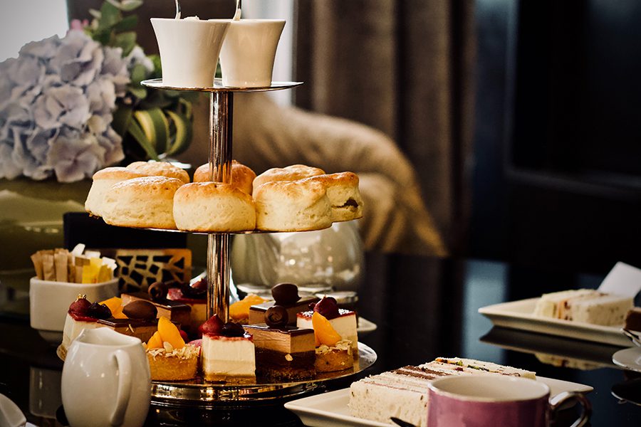 Three-tier cake stand with different confectionaries for high tea.