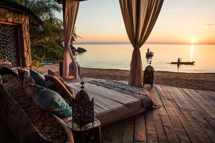 A daybed overlooking Lake Malawi at sunset at Kaya Mawa Lounge 