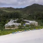 Aerial view of Acajou Beach Resort and beachfront.