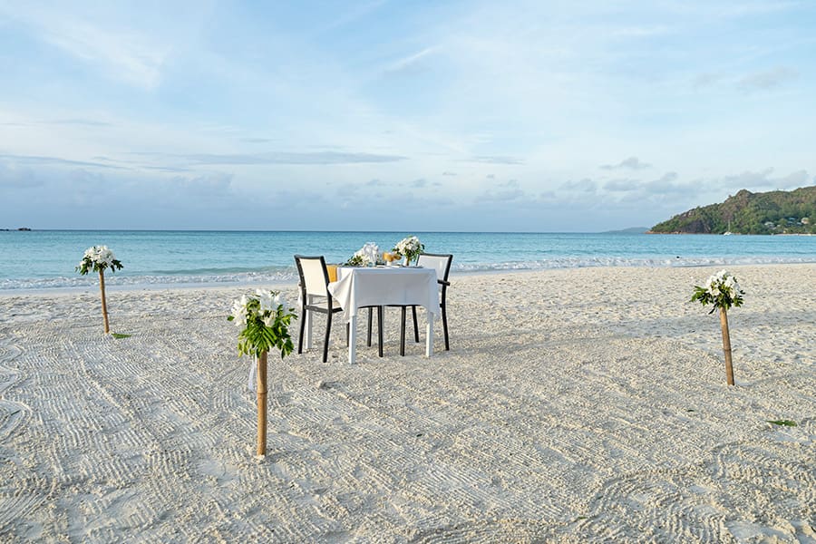 Request a romantic beach dinner.