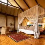 Spacious rooms with beds protected by mosquito netting. 
