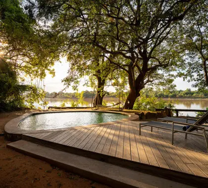 The swimming pool deck overlooks the river. 