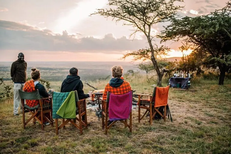 Sundowners prelude a night game drive.