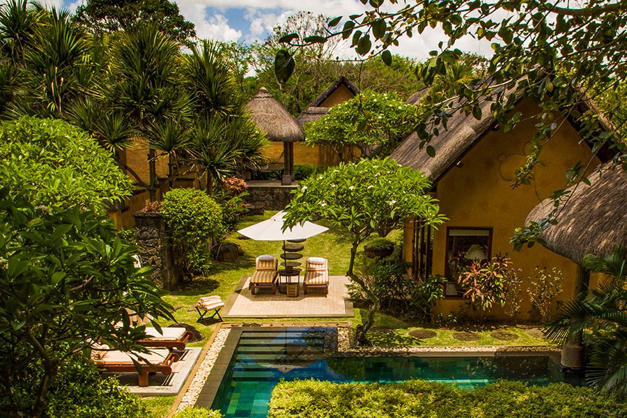 A thatched villa with loungers and a pristine pool in Mauritius | Go2Africa