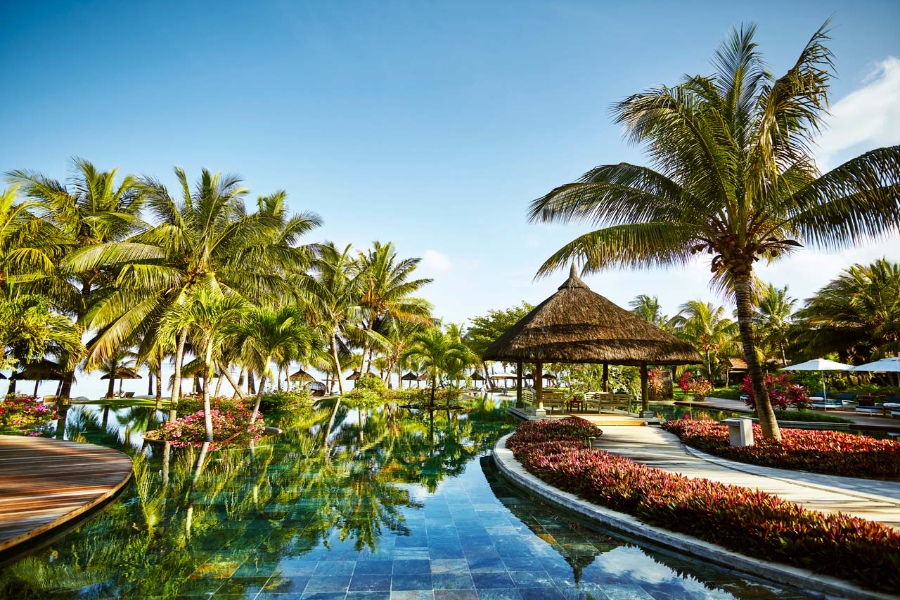Pools, palm trees, and pathways at LUX* Le Morne in Mauritius | Go2Africa