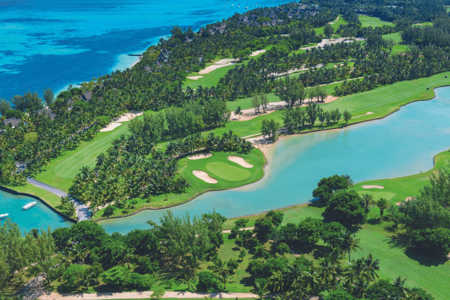 An aerial view of a large golf course and lagoon at Paradis Beachcomber Golf Resort & Spa in Mauritius | Go2Africa