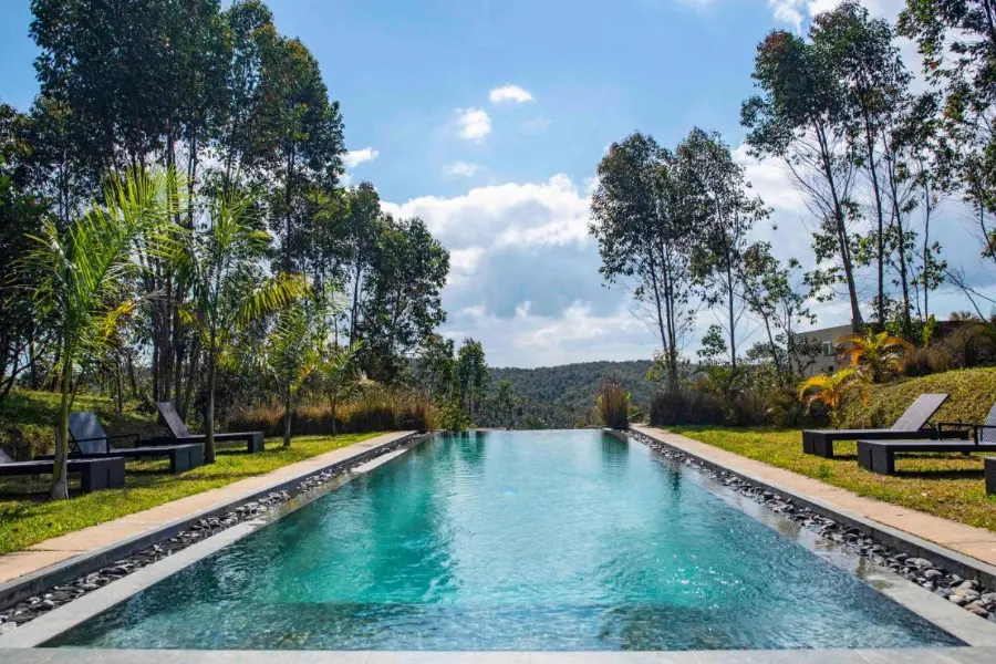 A large rimflow pool with surrounding loungers at Mantadia Lodge, Madagascar | Go2Africa