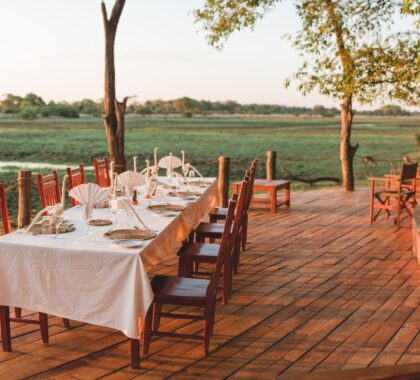 A beautifully laid table at sunset overlooking the views from Musekese Camp | Go2Africa