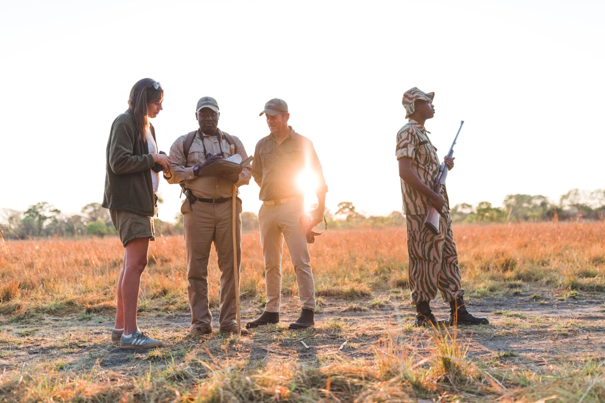 Four people embarking on a walking safari in Kafue National Park with Musekese Camp | Go2Africa