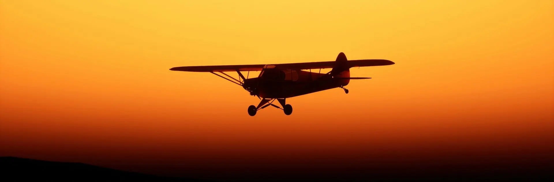 A small plane silhouetted against a sunset | Go2Africa