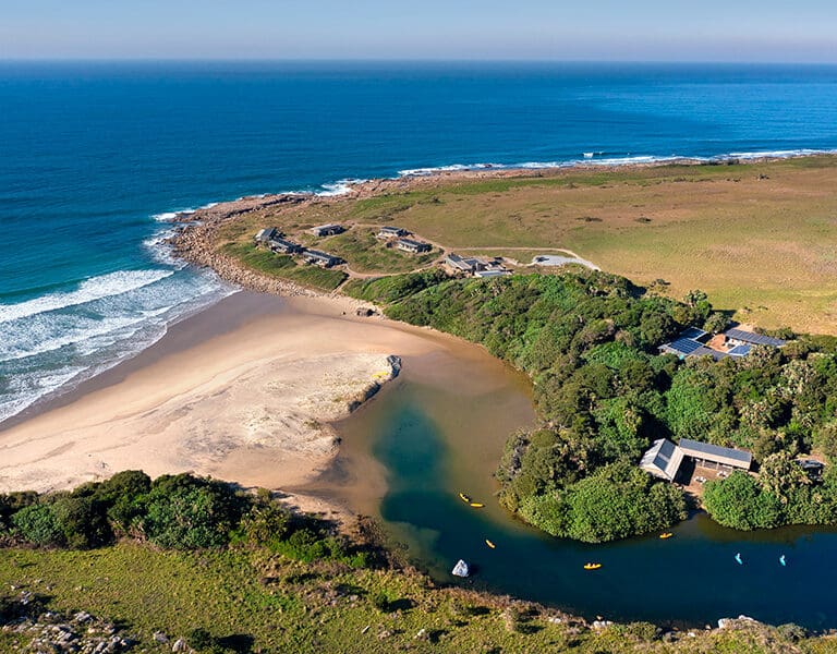 The lodge is set next to a sandy cove with a river perfect for kayaking | GweGwe Beach Lodge.