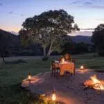 A romantic dinner set up in the wild. 