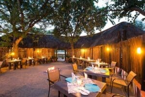 An outdoor boma dining area creates a romantic ambiance. 