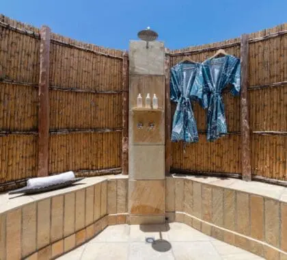 A serene outdoor shower setting.
