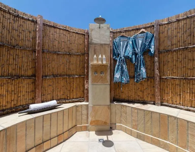 A serene outdoor shower setting.
