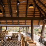 The lodge deck has views out over the Sand River.
