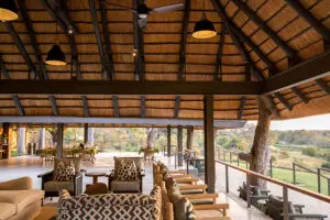 The lodge deck has views out over the Sand River. 