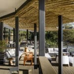 La zona principal del lodge Sanctuary Olonana incluye una amplia terraza y un salón con vistas al río.