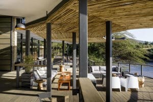 La zona principal del lodge Sanctuary Olonana incluye una amplia terraza y un salón con vistas al río.