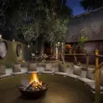 Swap stories of the day's sightings around the campfire at Ulusaba Safari Lodge.